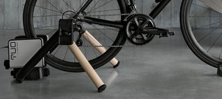 A black bike mounted to the Elite TUO smart wheel-on trainer