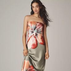 model wears strapless slip dress with large floral print while posing for the camera