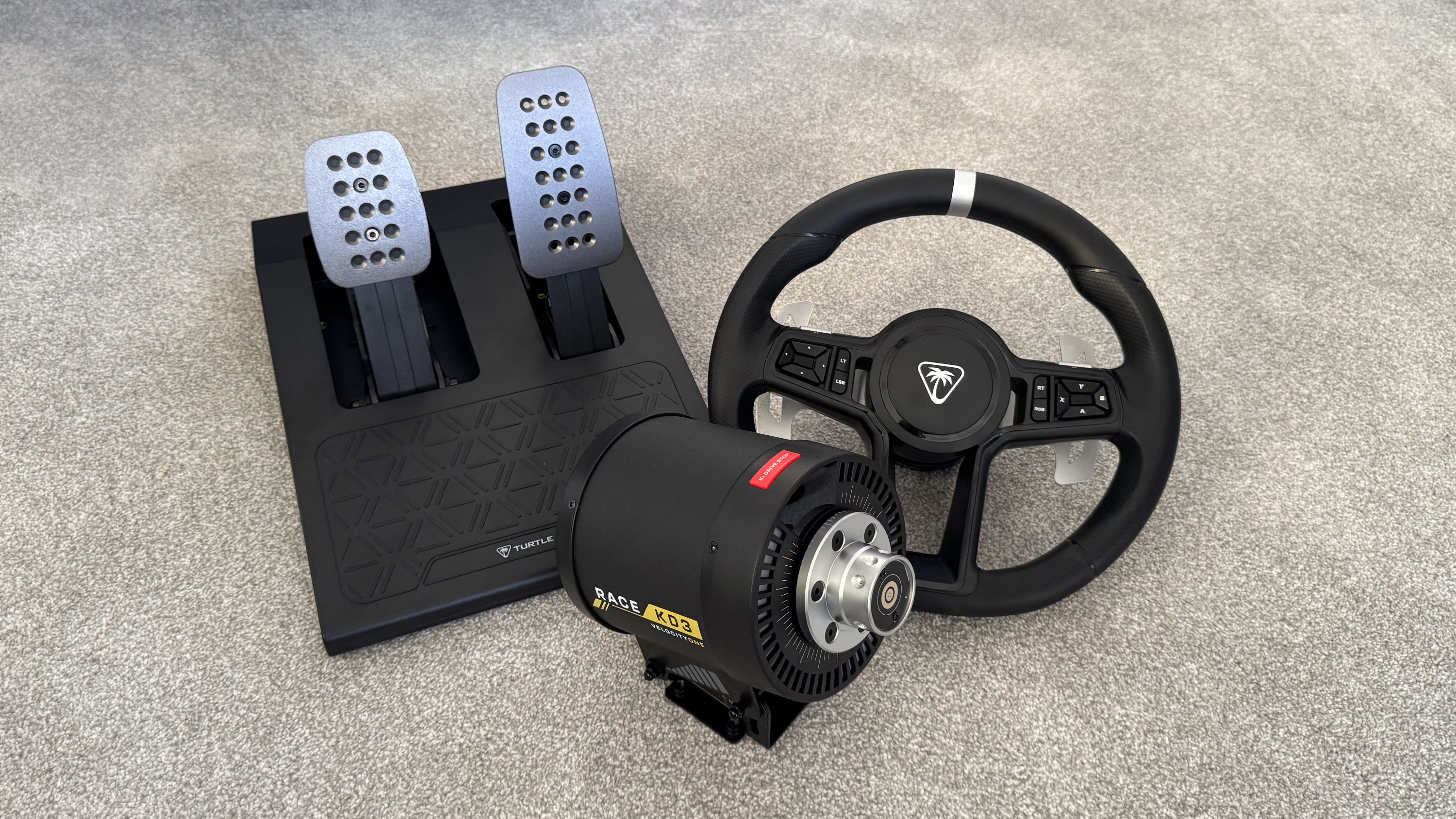 The Turtle Beach VelocityOne Race KD3 bundle laid out on a carpet