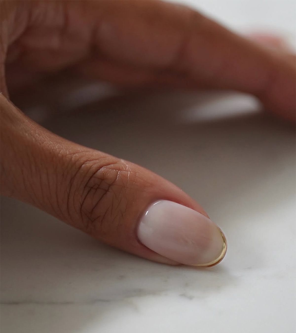 A manicure with gold tips by Iram Shelton.