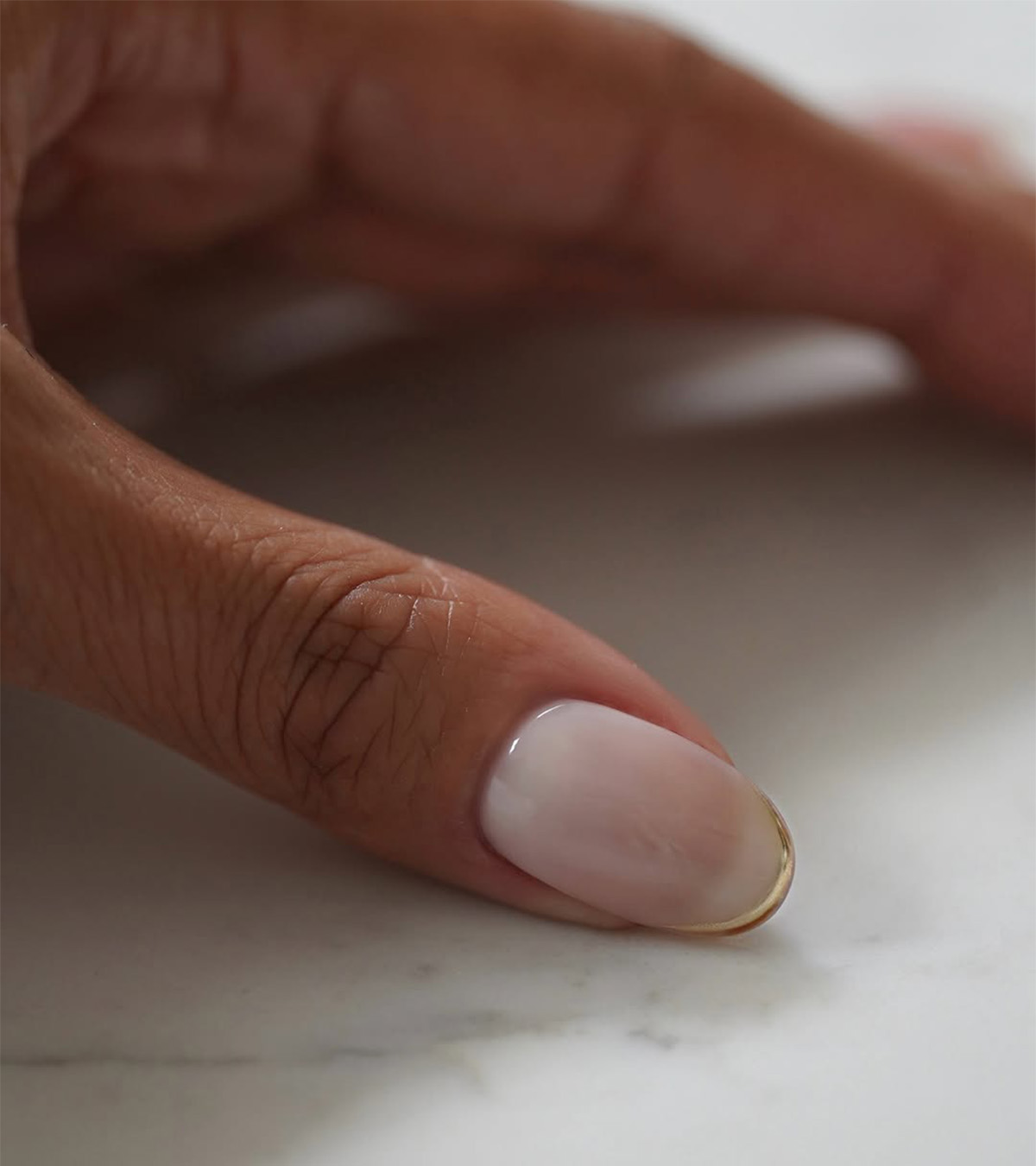 A manicure with gold tips by Iram Shelton.