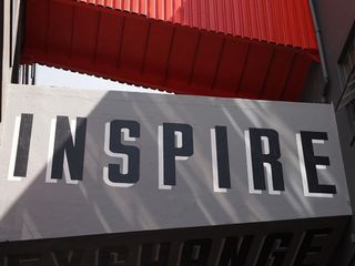Grey sign with "INSPIRE" wrote on