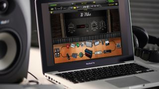 Home studio setup with a laptop running AmpliTube
