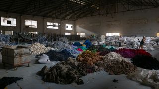 piles of textile waste at recycling facility