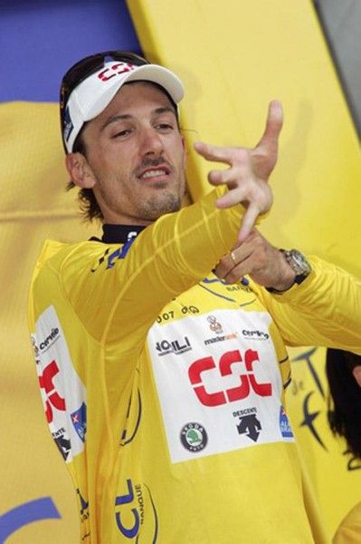Cancellara reaches an arm into his second yellow jersey of the 2007 Tour