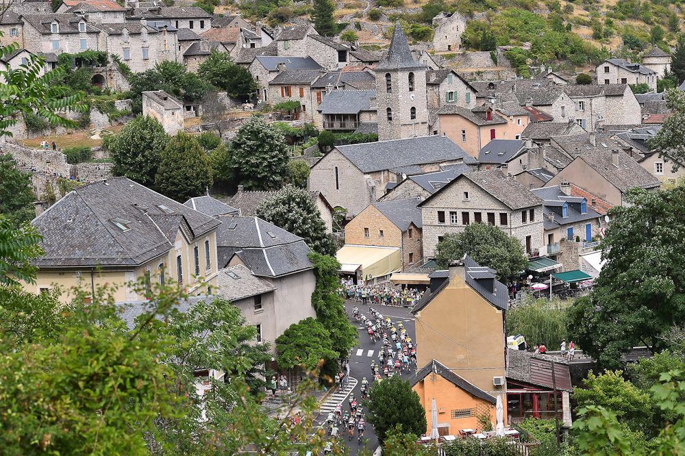 The peloton rolls though a French village during stage 14.