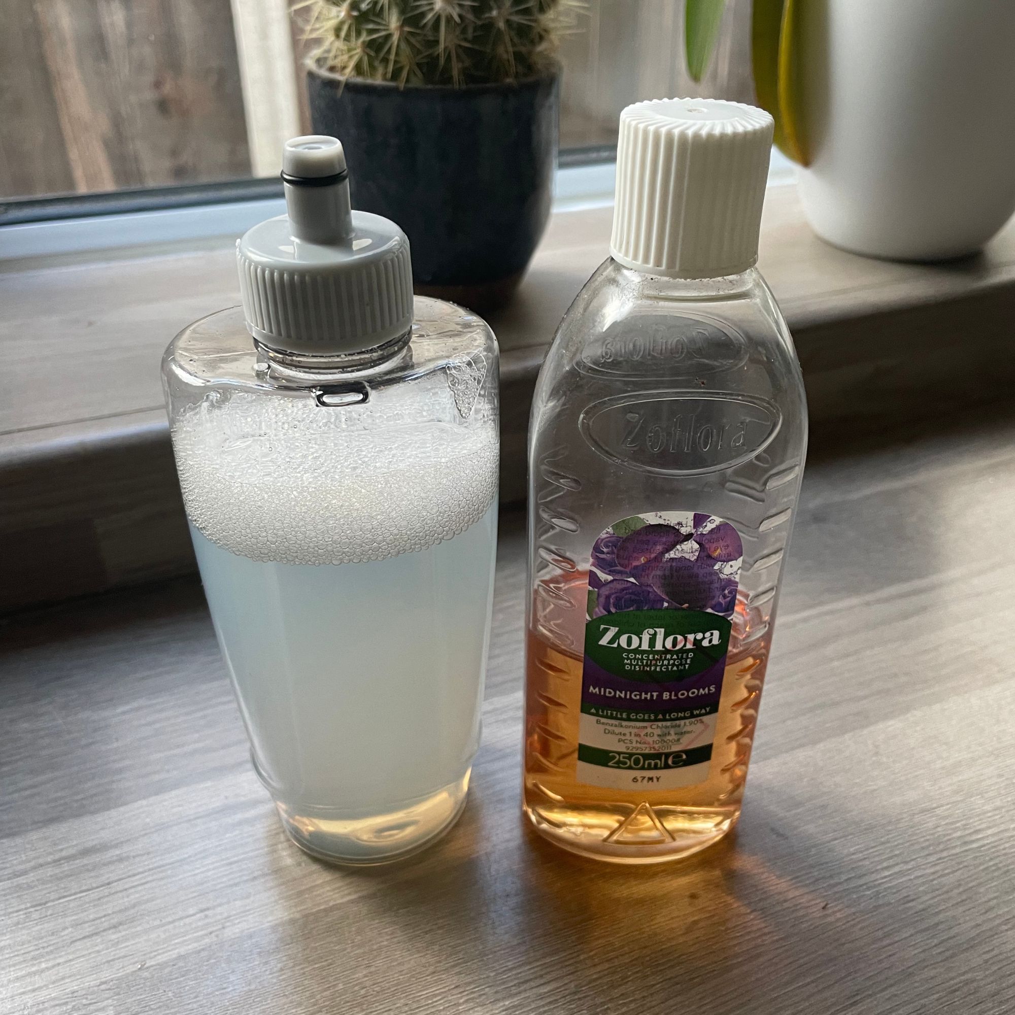 Minky mop bottle next to a bottle of zoflora