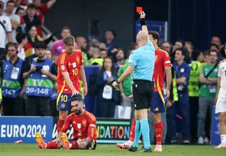 Referee Anthony Taylor shows a red card to Daniel Carvajal of Spain, following a second yellow card for a foul on Jamal Musiala of Germany during during the UEFA EURO 2024 quarter-final match between Spain and Germany at Stuttgart Arena on July 05, 2024 in Stuttgart, Germany. (Photo by Stefan Matzke - sampics/Getty Images)