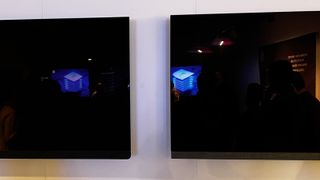 Philips OLED908 on left with dim reflection of a light, Philips OLED907 on right with brighter reflection of the same light