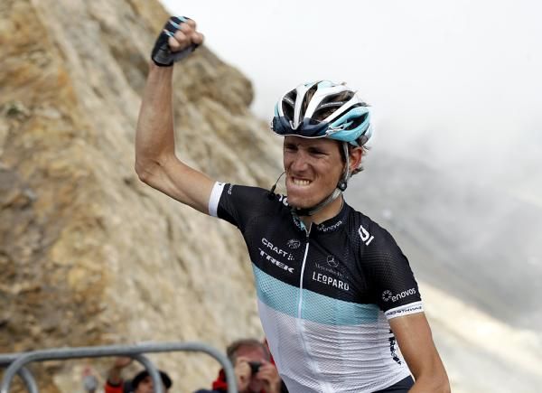 Andy Schleck gives one more fist pump before nearly plowing into the assembled photographers