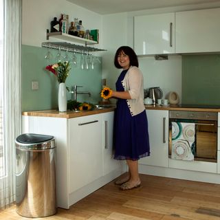 kitchen room with wooden worktop and flower vase with cabinets