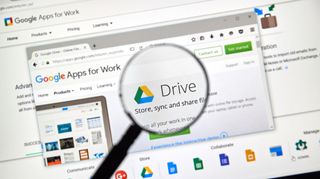G Suite on laptop under a magnifying glass