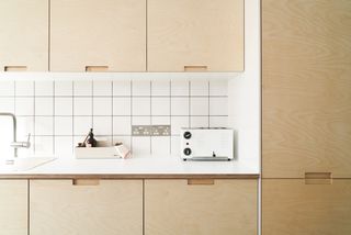 kitchen with plywood cabinets and white tiles by plykea