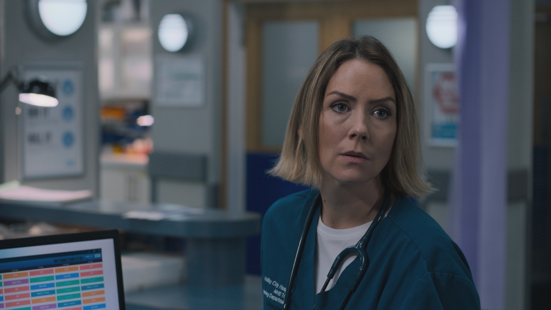 Stevie Nash stands in Holby ED with a faraway look.