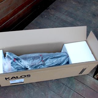 The Kettler Kalos copper lantern patio heater being unboxed on wooden decking