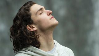 Man breathing deeply outside, sleep &amp; wellness tips