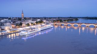 uniworld river ship docked at night in Bordeaux