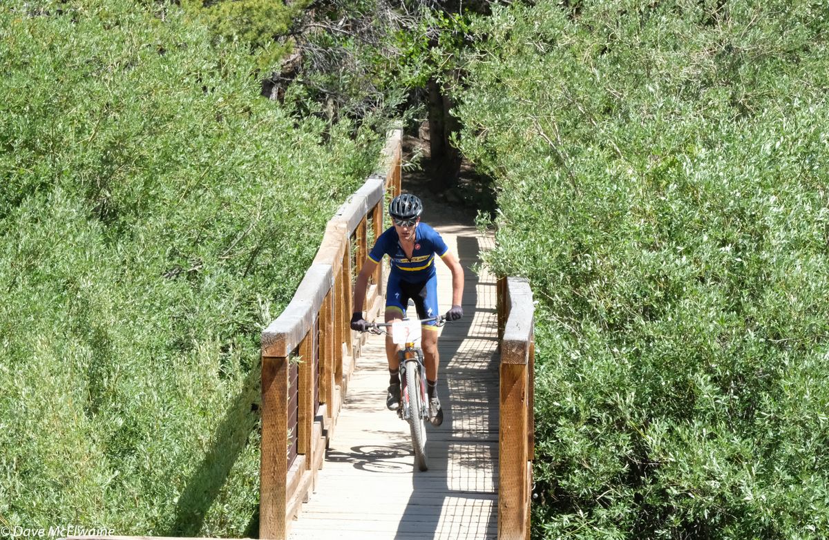 J.J. Clark (Pro Cycling) crossing one of the wooden bridges over a stream in French Gulch on his way to a fourth-place finish