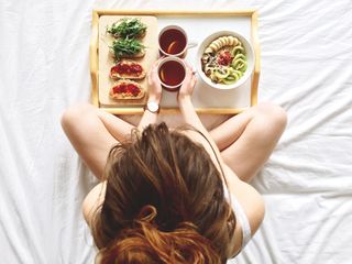 Directly Above Shot Of Woman Having Breakfast On Bed - stock photo