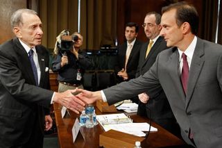 USADA chief Travis Tygart (R) shakes hands with Senator Arlen Specter at a 2009 hearing in Washington, DC about screening dietary supplements for illegal steroids.