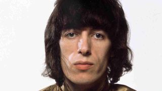 Rolling Stones bassist Bill Wyman posing for a photograph in 1969