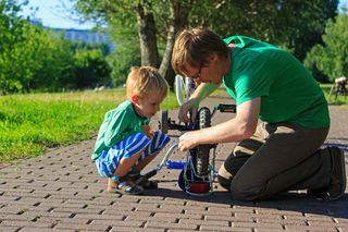 Dad and son fixing bike, strategy, depression, struggle