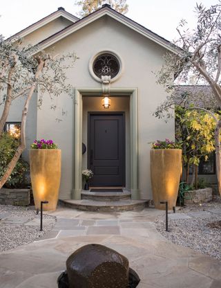 Front yard with symmetrical plant containers by the door
