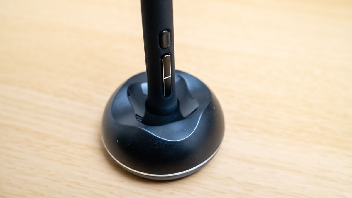 The pen stand for a Huion Kamvas 16 (Gen 3) drawing tablet on a wooden desk