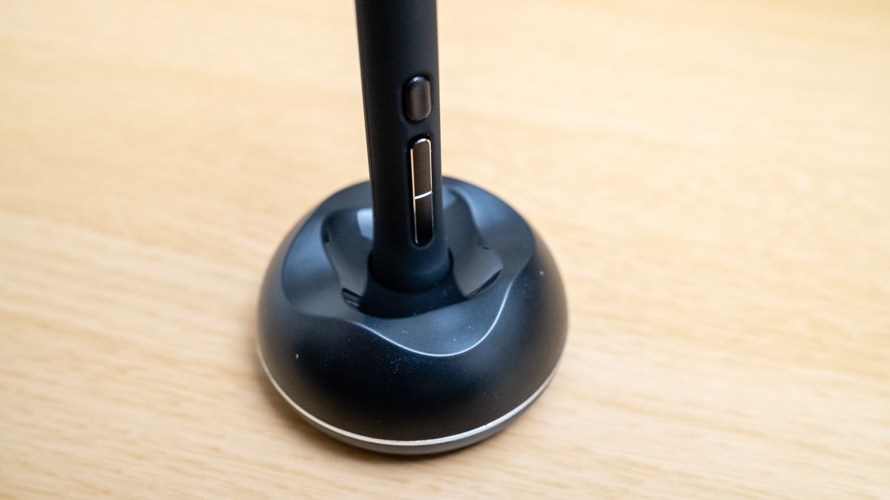 The pen stand for a Huion Kamvas 16 (Gen 3) drawing tablet on a wooden desk