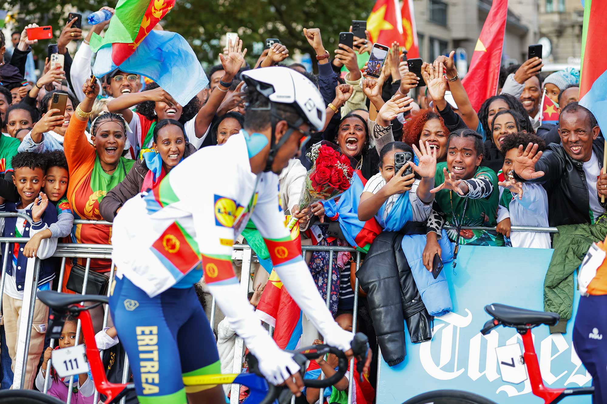 Picture by Ed SykesSWpixcom 29092024 2024 UCI Road and Paracycling Road World Championships Zurich Switzerland Men Elite Road Race Natnael Tesfazion Eritrea passes fans fro his home country Eritrea