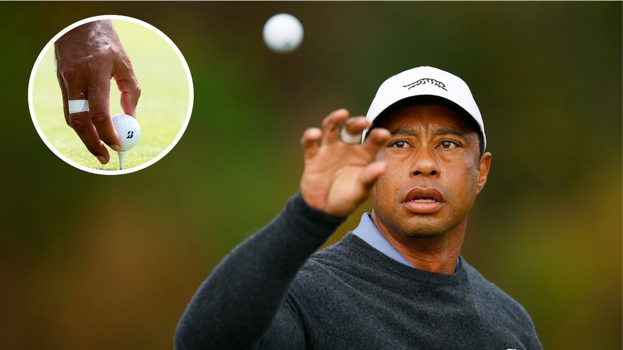 Tiger Woods catches a golf ball and puts it on the tee