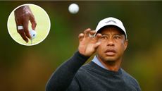 Tiger Woods catches a golf ball and puts it on the tee