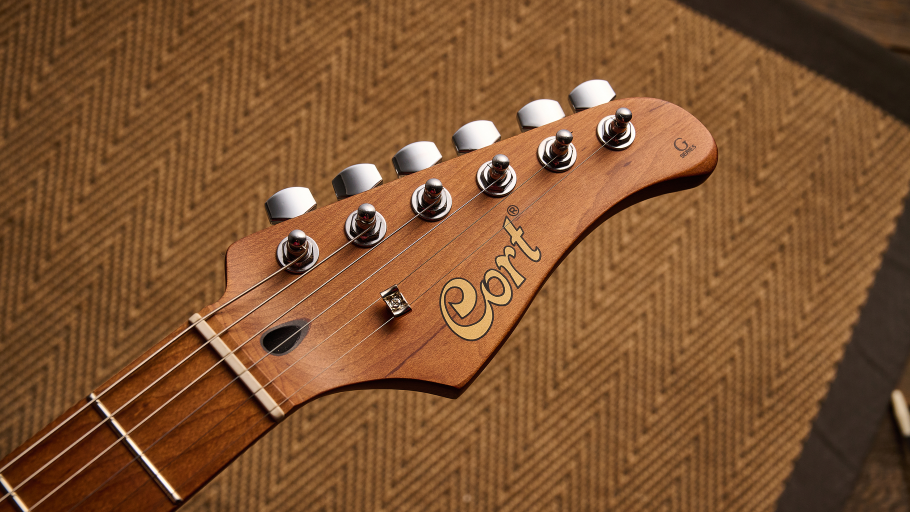 The headstock of a Cort G200SE electric guitar