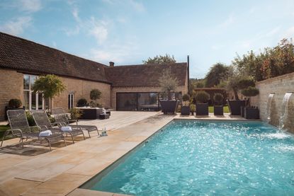 Swimming pool with fountains and seating areas