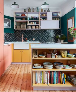 yellow and pink kitchen cabinets with green tiles