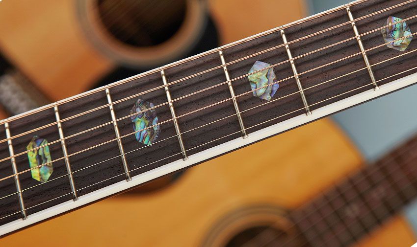 Its upmarket style means tasteful bling, including this white bound fingerboard with its abalone hexagon inlays