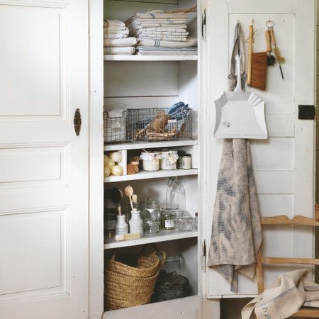 A cleaning cupboard with cleaning supplies