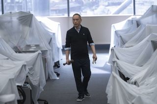 ken leung as eric walking with a bat through the closed pierpoint london office in industry season 3 finale