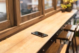 Phone left on bar in coffee shop
