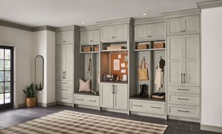 extensive mudroom cabinets incorporating noteboard