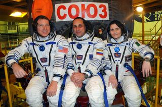 NASA astronaut Terry Virts (left), Russian cosmonaut Anton Shkaplerov and Italian astronaut Samantha Cristoforettie of the European Space Agency pose for a crew photo with their Soyuz spacecraft ahead of a Nov. 23, 2014 launch from Baikonur Cosmodrome, Kazakhstan.