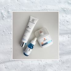 three la roche posay products including a sunscreen, serum, and dark spot treatment on a background of bubbly skincare products