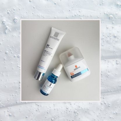 three la roche posay products including a sunscreen, serum, and dark spot treatment on a background of bubbly skincare products