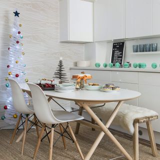 white kitchen diner with skinny Christmas tree