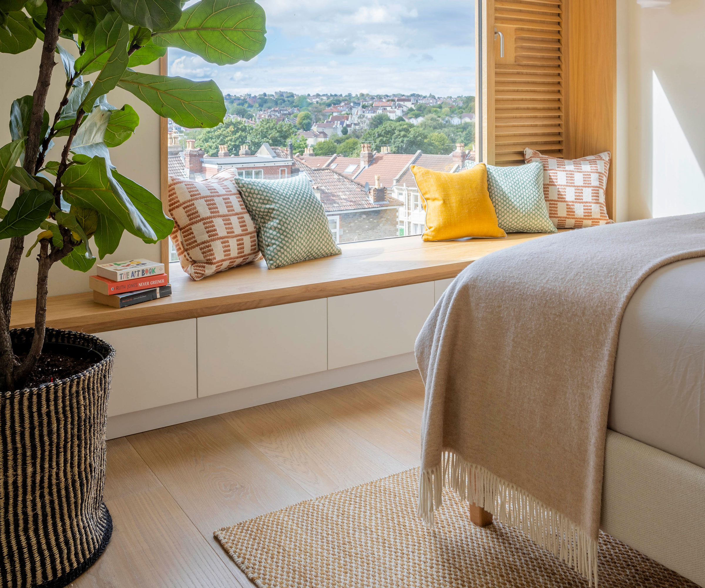loft conversion bedroom with picture window and window seat