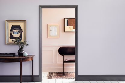 lavender entryway leading to a pink living room
