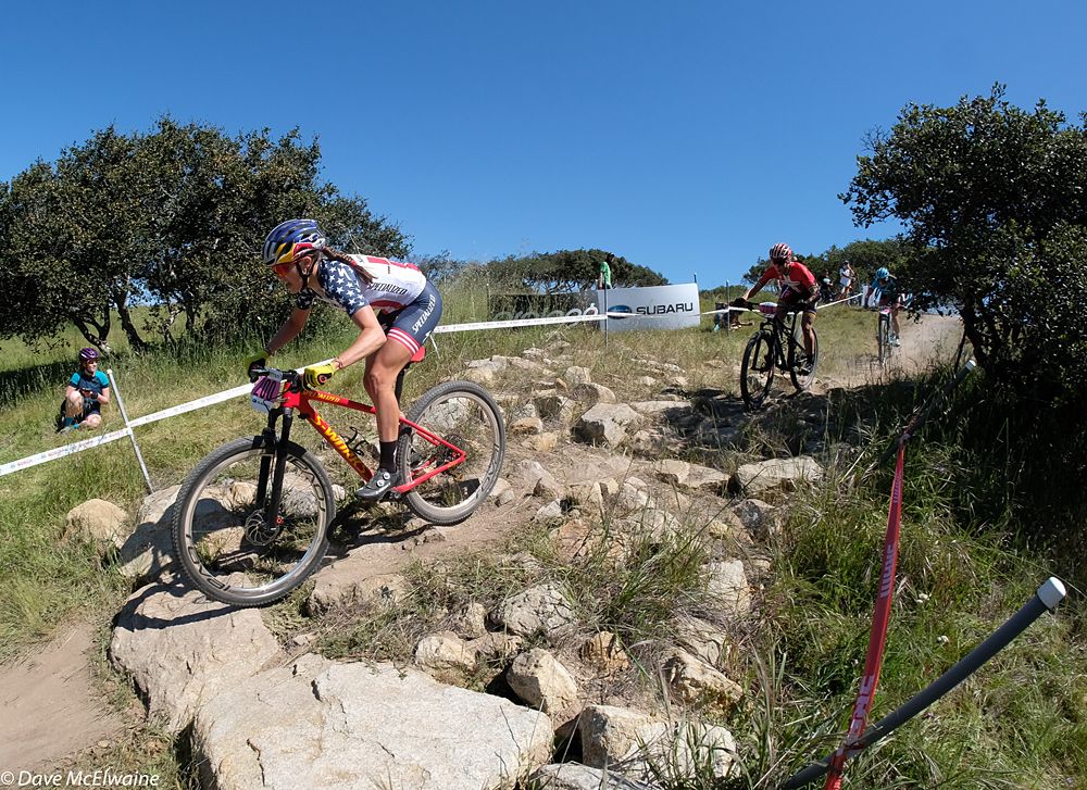 Kate Courtney (Specialized) descends over a rock garden with the race lead
