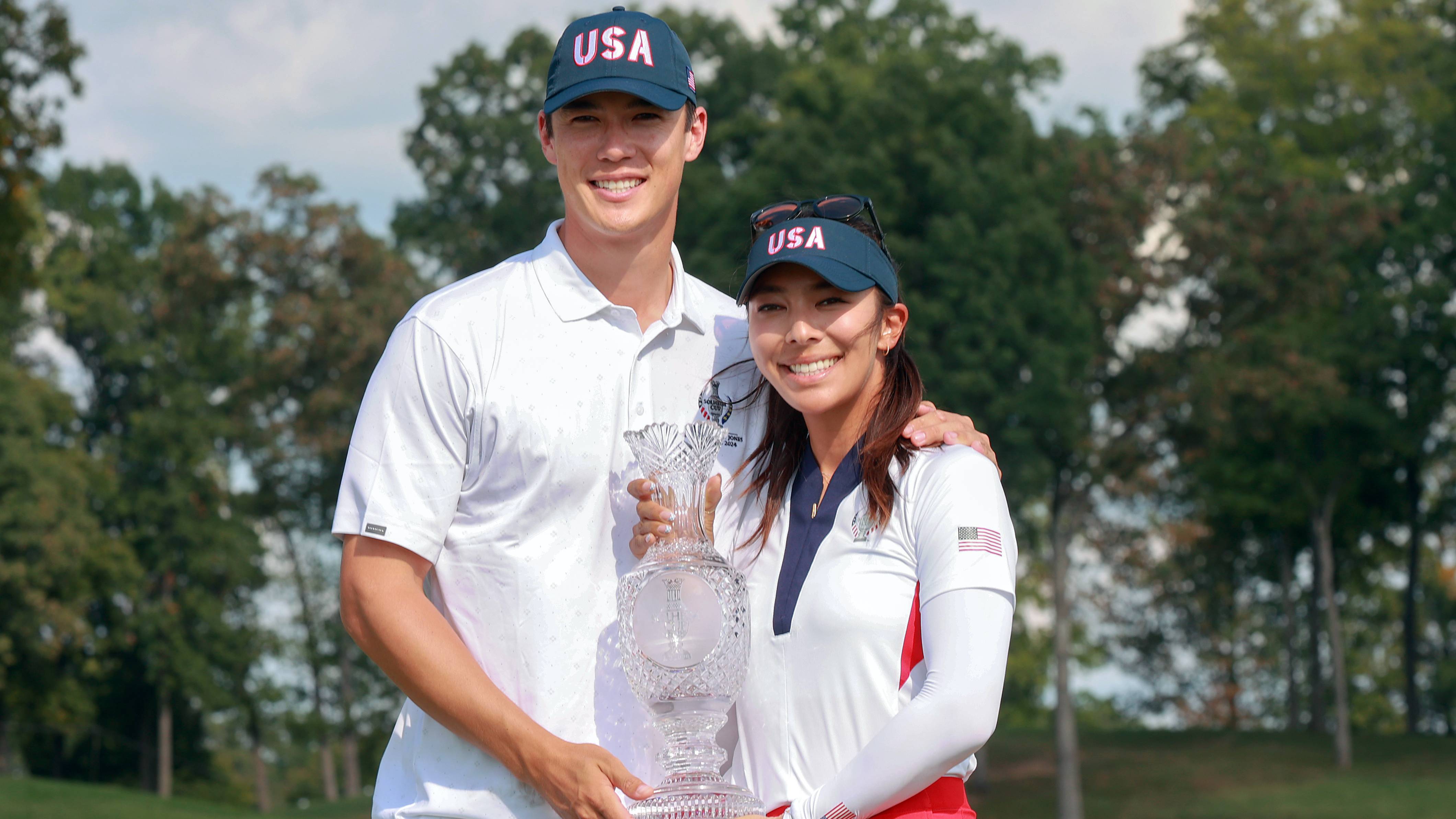 Alison Lee and partner Trey Kidd pose with the Solheim Cup trophy in 2024