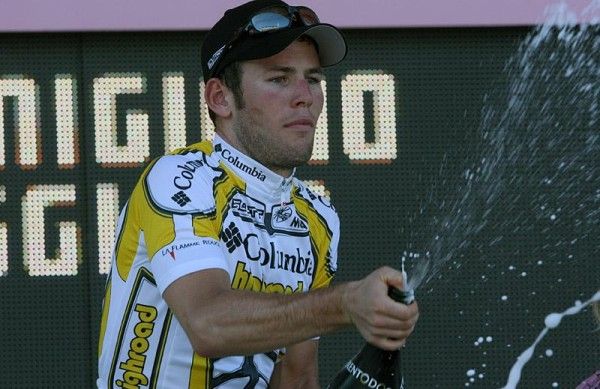 Stage winner Mark Cavendish uncorks the bubbly on the podium.
