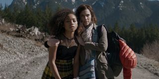 Logan Browning and Allison Williams walking on a dirt road in The Perfection